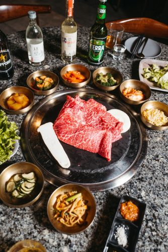 a table topped with bowls and plates of food